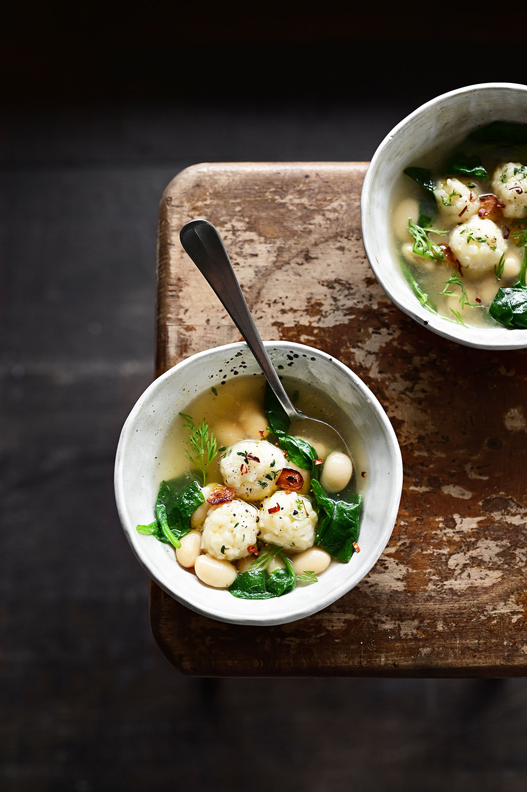 serving dumplings | Parmesan rice ball soup with spinach and butter beans