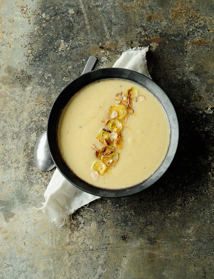 Roasted cauliflower apple soup with crispy brussels sprouts and hazelnuts