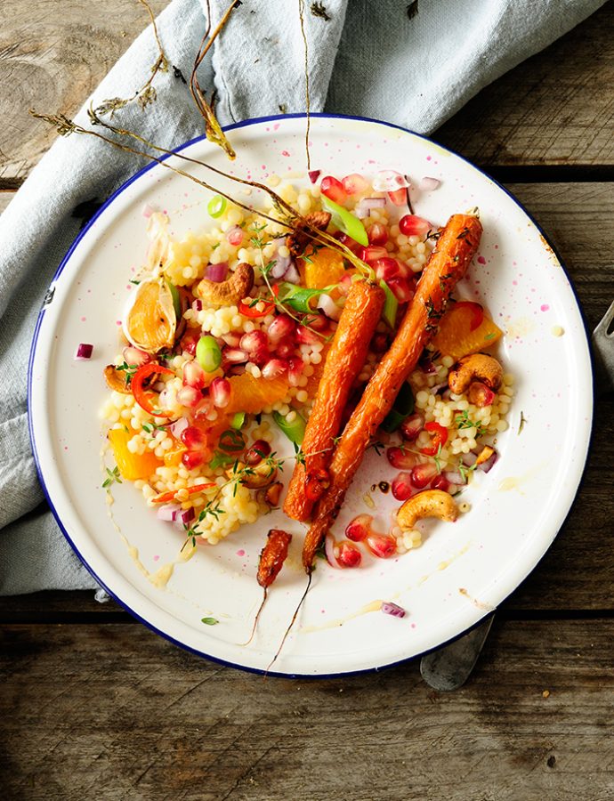 Pearl couscous with caramelized carrots, cashew nuts and pomegranate
