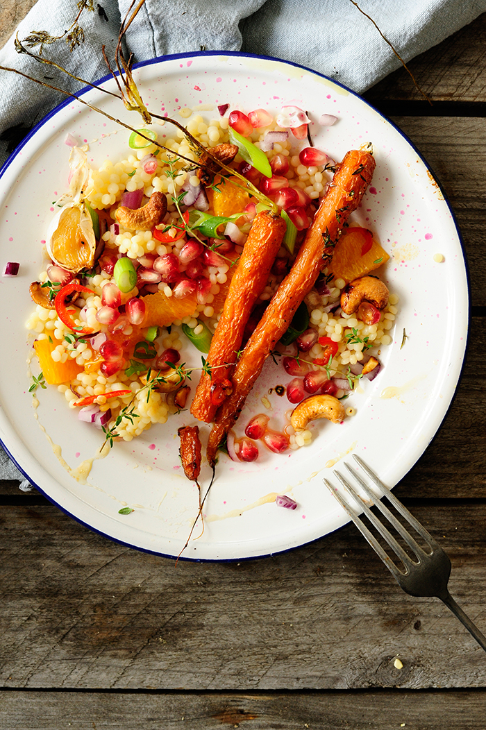 Pearl couscous with caramelized carrots, cashew nuts and pomegranate