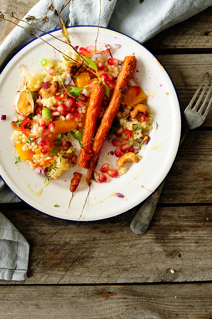 Pearl couscous with caramelized carrots, cashew nuts and pomegranate