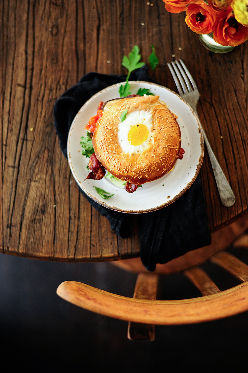 Bagel egg in a hole with hummus and roasted veggies