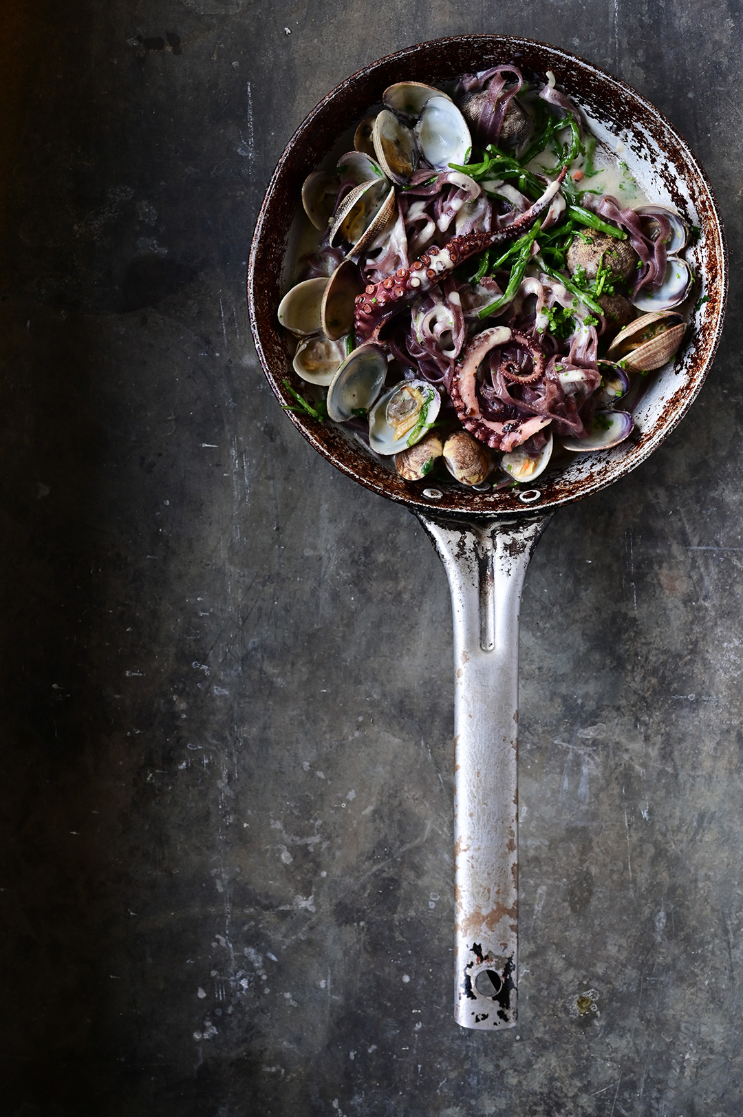 Creamy garlic black pasta with clams and octopus