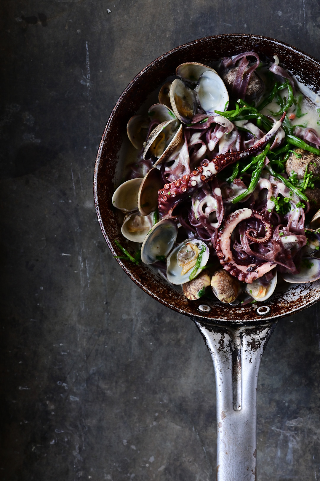 Creamy garlic black pasta with clams and octopus