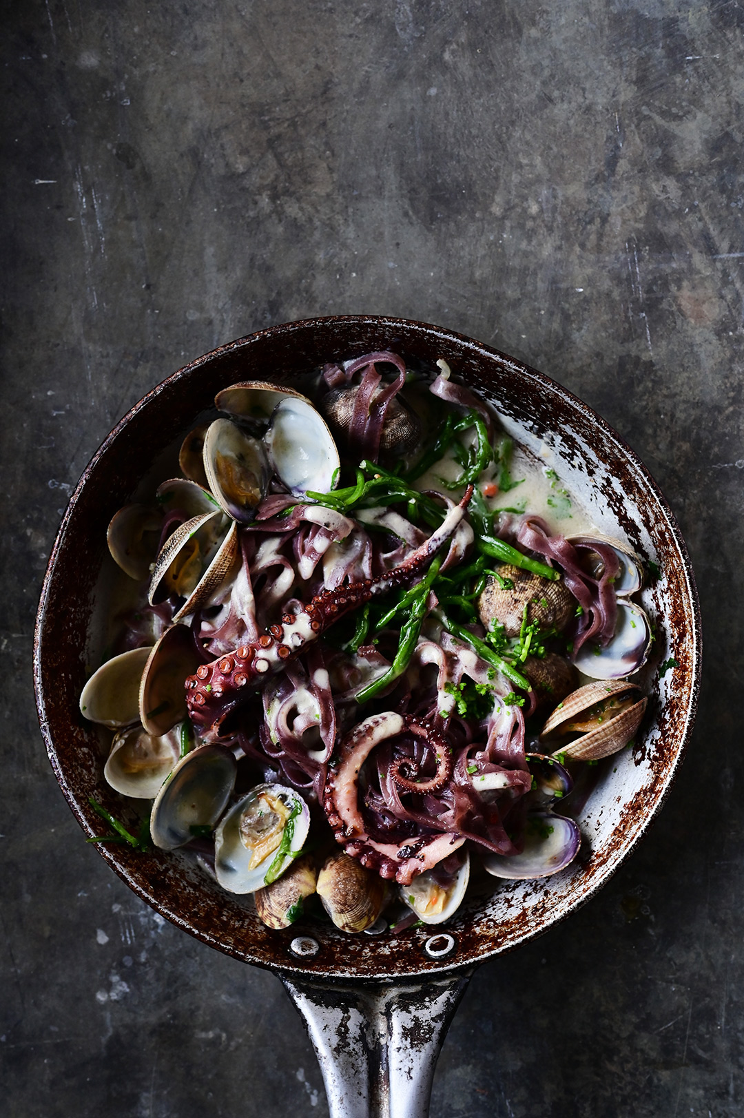 Creamy garlic black pasta with clams and octopus