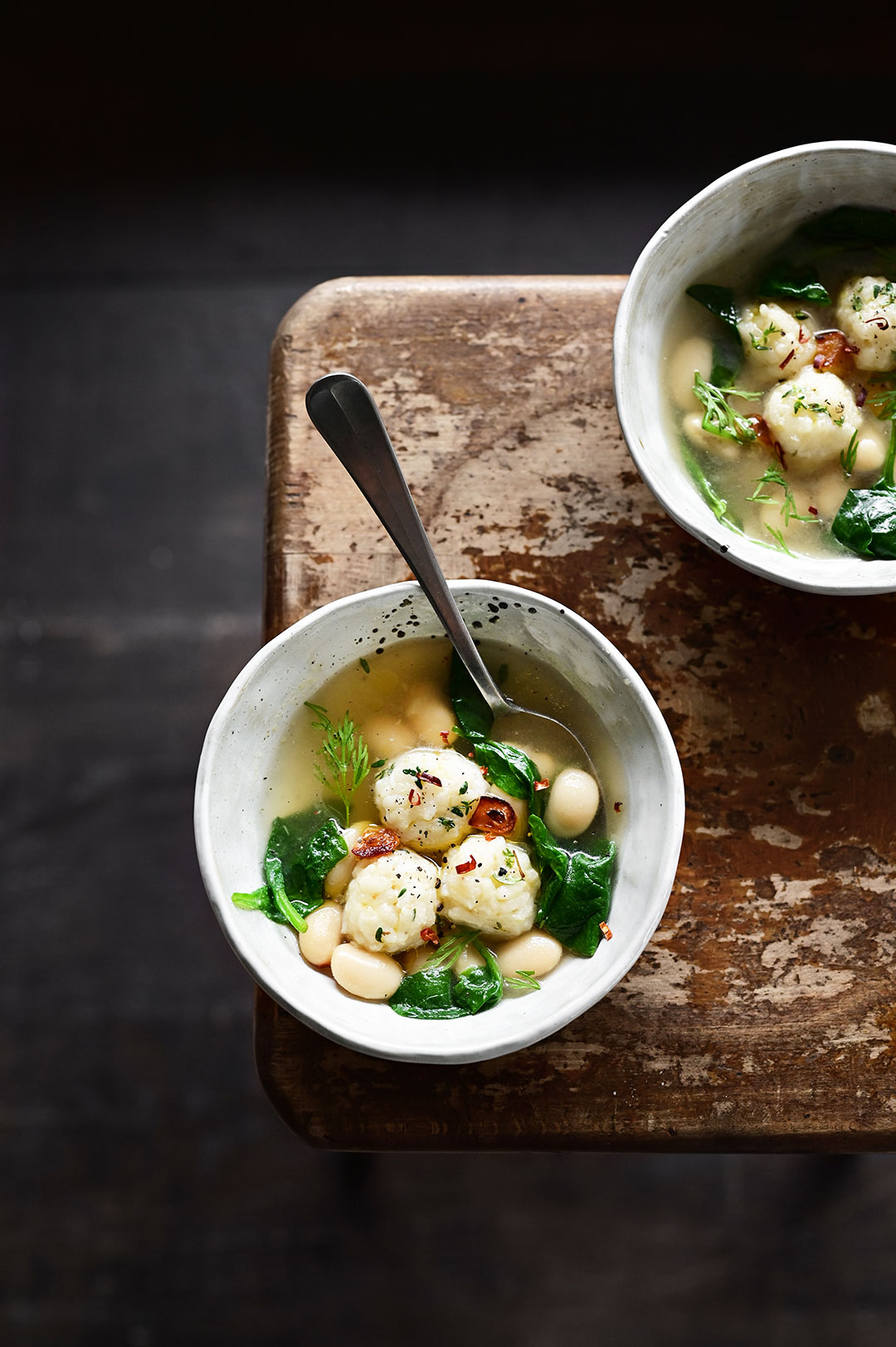 Parmesan rice ball soup with spinach and butter beans