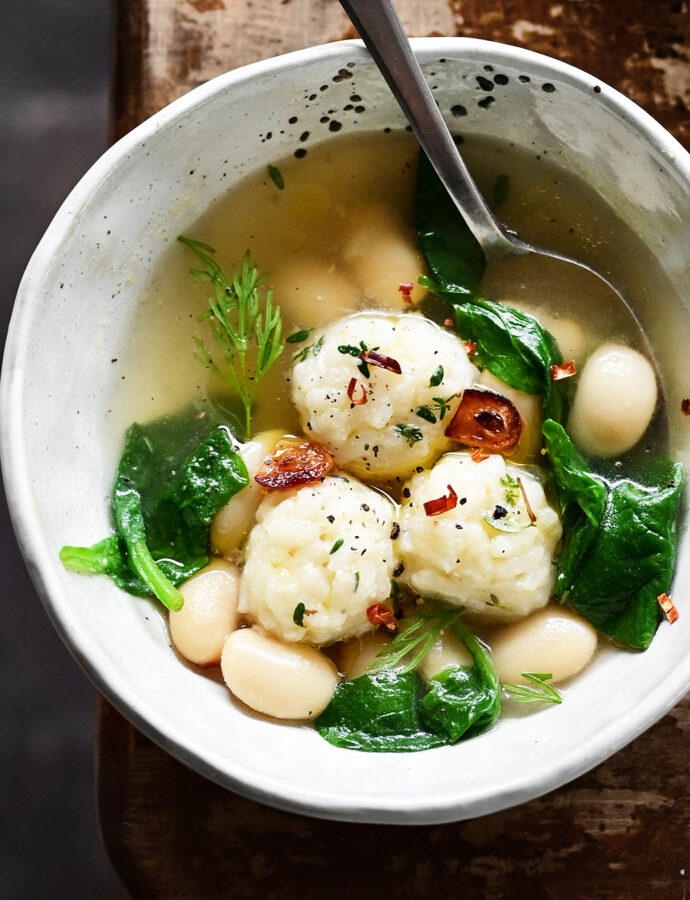 Parmesan rice ball soup with spinach and butter beans