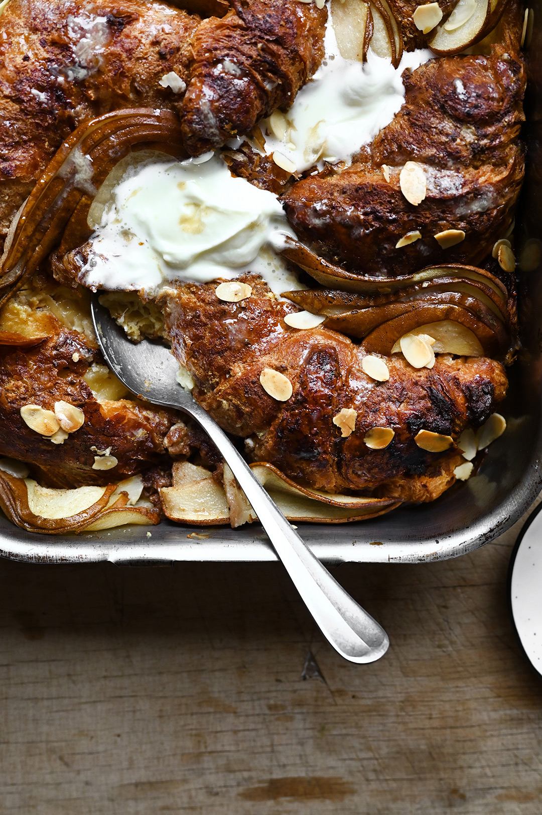 serving dumplings | Overnight pear and ricotta croissant French toast with almonds