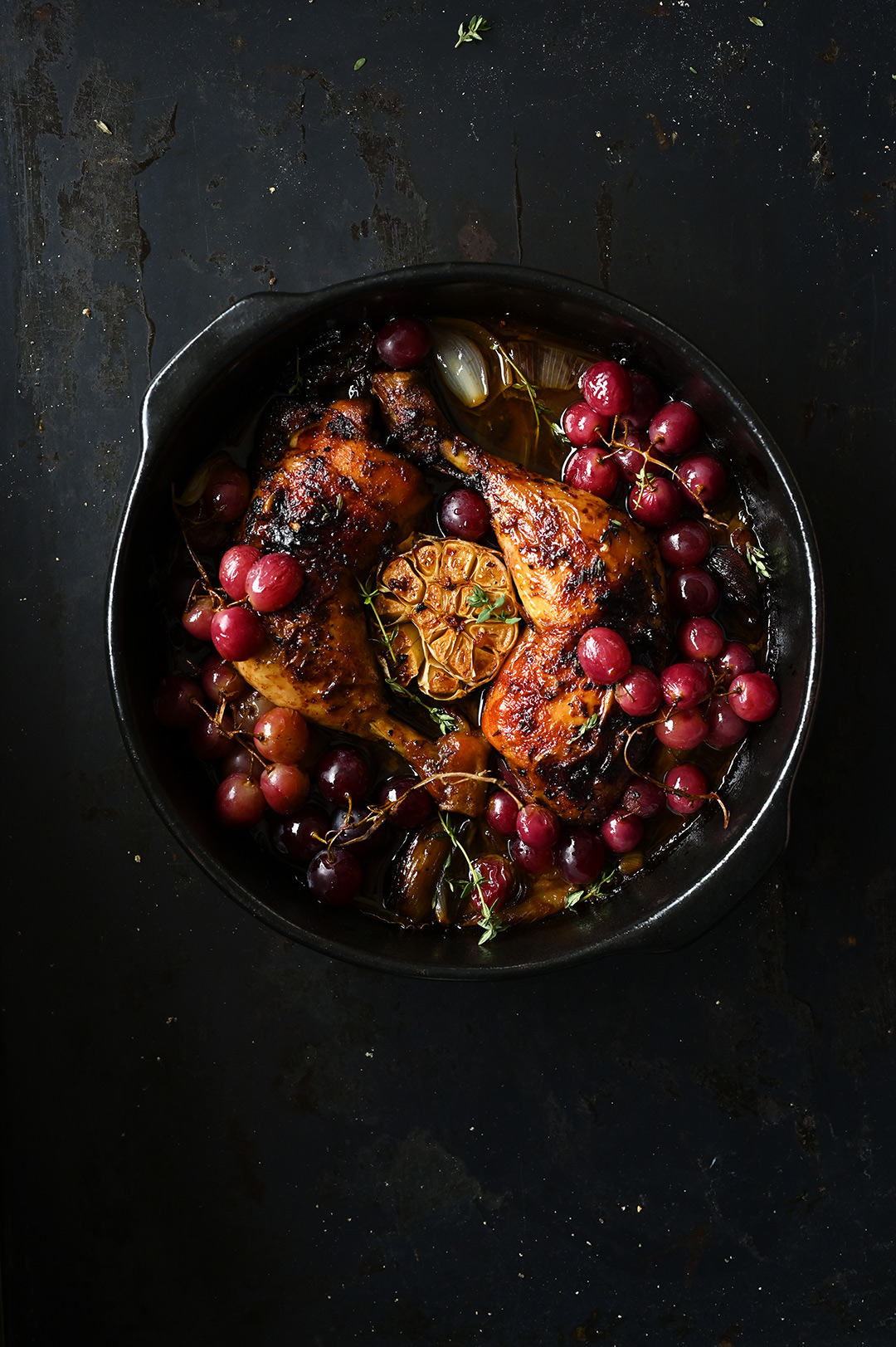 Roast chicken legs with garlic and grapes