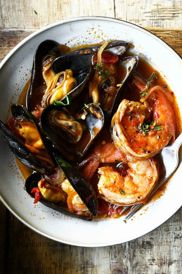 Mussels and Shrimp in Garlic Tomato Sauce Serving Dumplings