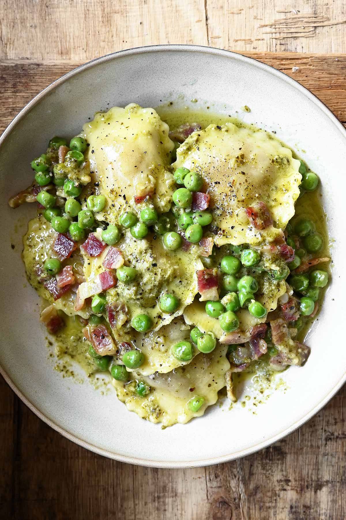 pesto ravioli with pancetta and peas