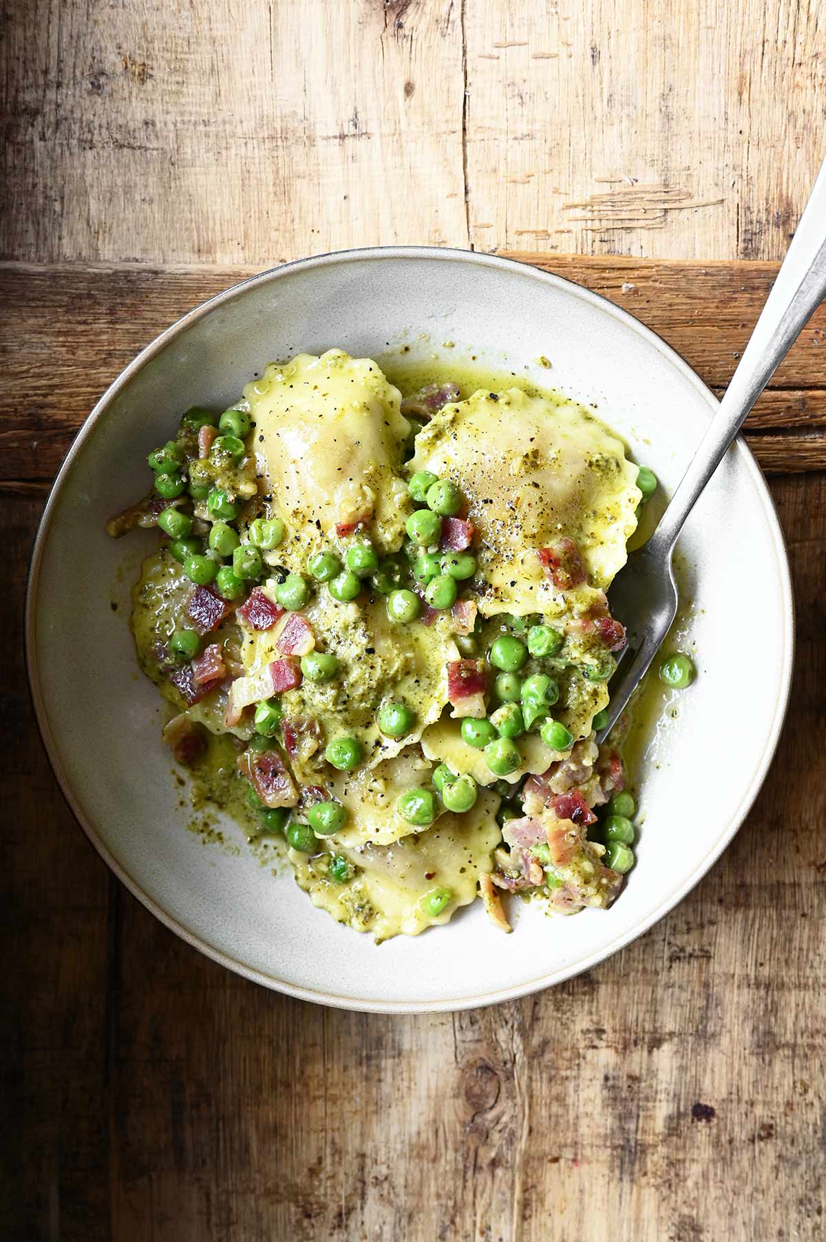 pesto ravioli with pancetta and peas